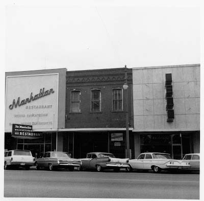 A black and white photo from 1958 of the outside of a restaurant called Manhattan.