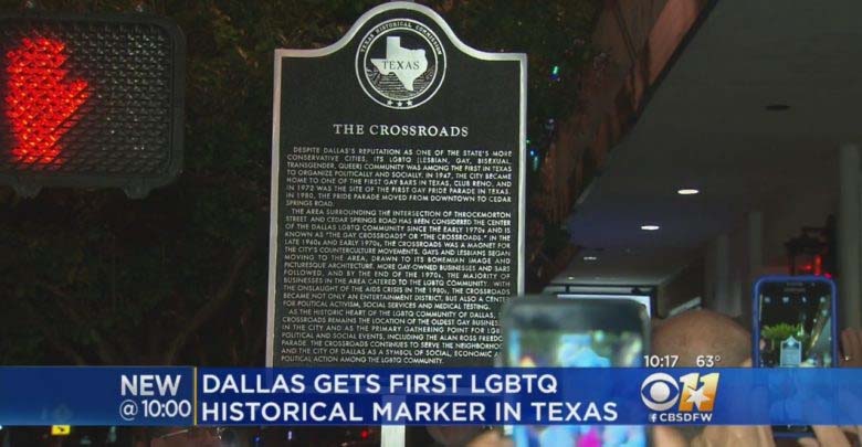 A screenshot from a 2018 news broadcast with the headline "Dallas gets first LGBTQ historical marker in Texas" and shot of a large plaque.